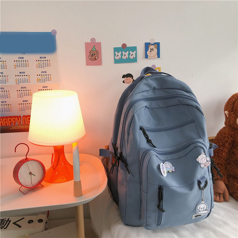 Sac à dos grande capacité pour filles et étudiantes, imperméable, multi-poches, bretelles confortables. Disponible en 4 coloris. Idéal pour l'école et le quotidien.