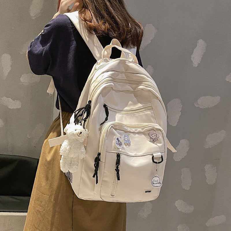 Sac à dos grande capacité pour filles et étudiantes, imperméable, multi-poches, bretelles confortables. Disponible en 4 coloris. Idéal pour l'école et le quotidien.