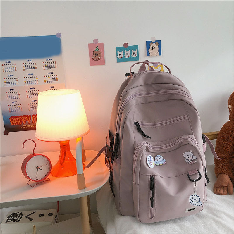 Sac à dos grande capacité pour filles et étudiantes, imperméable, multi-poches, bretelles confortables. Disponible en 4 coloris. Idéal pour l'école et le quotidien.